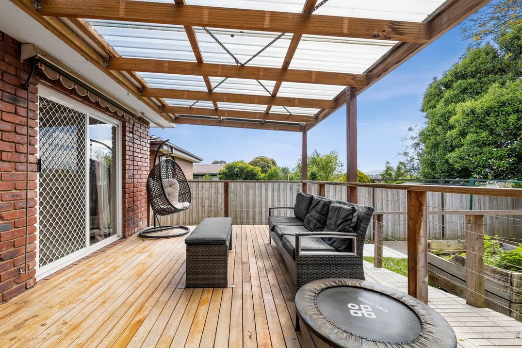 Backyard deck area with floating chair and couch