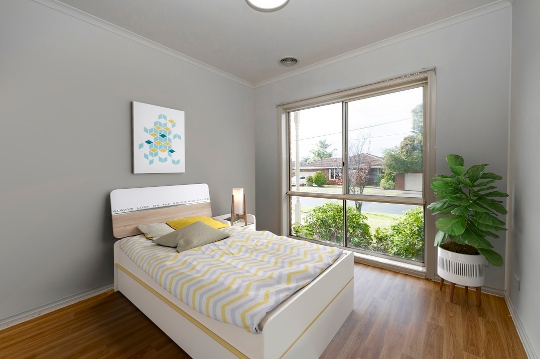 Bedroom with large window and wall art