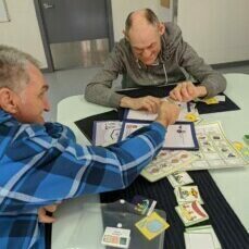 Colin and his housemate using communication aids in their SIL home