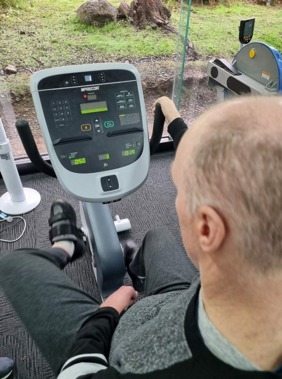 A man on a gym spin bike.