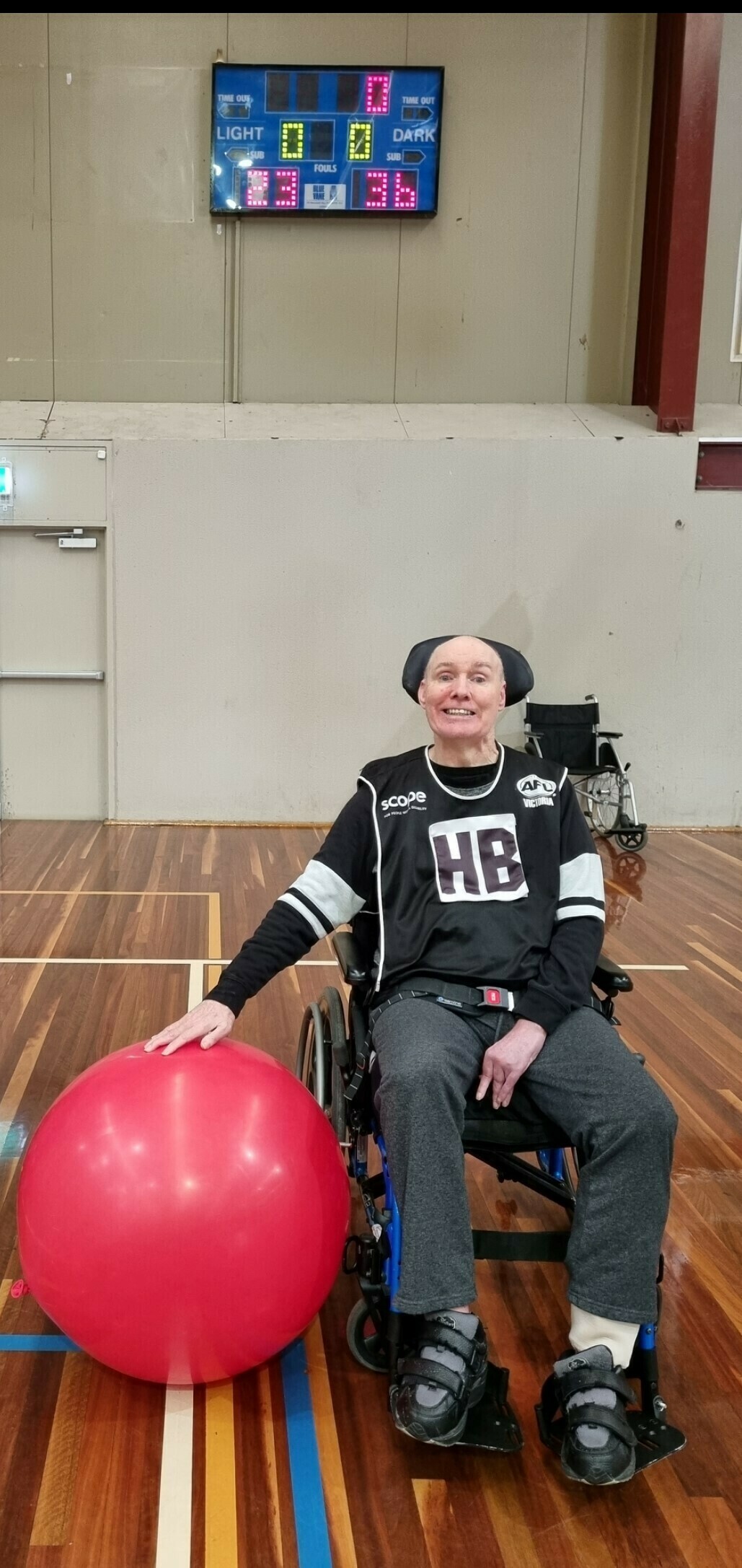 A man in a wheelchair and an exercise ball.