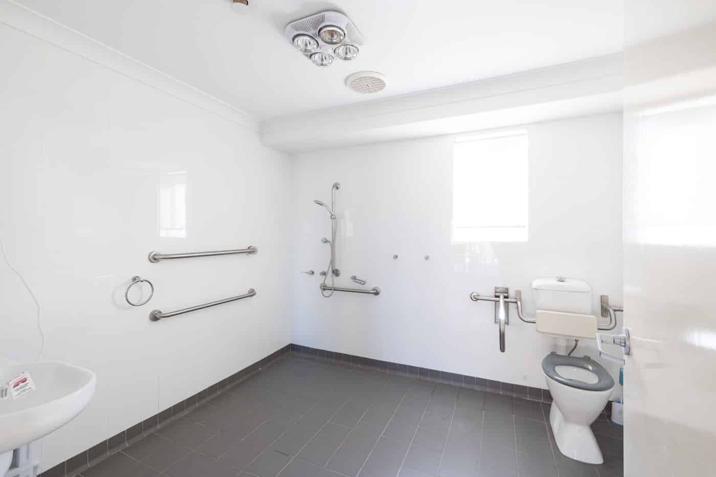 Large accessible bathroom with shower and toilet