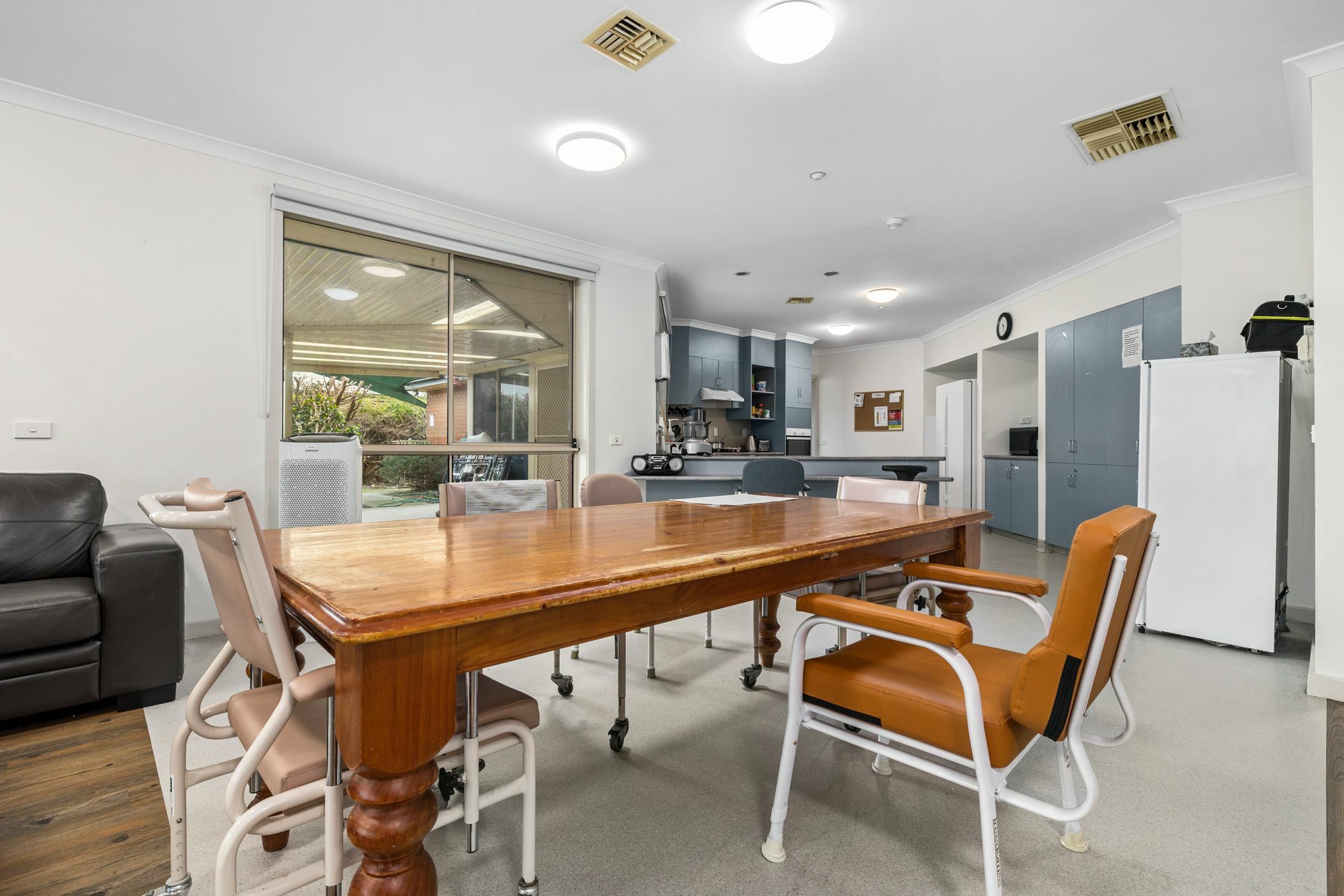 Dining area with wooden table in SDA home in Langwarrin