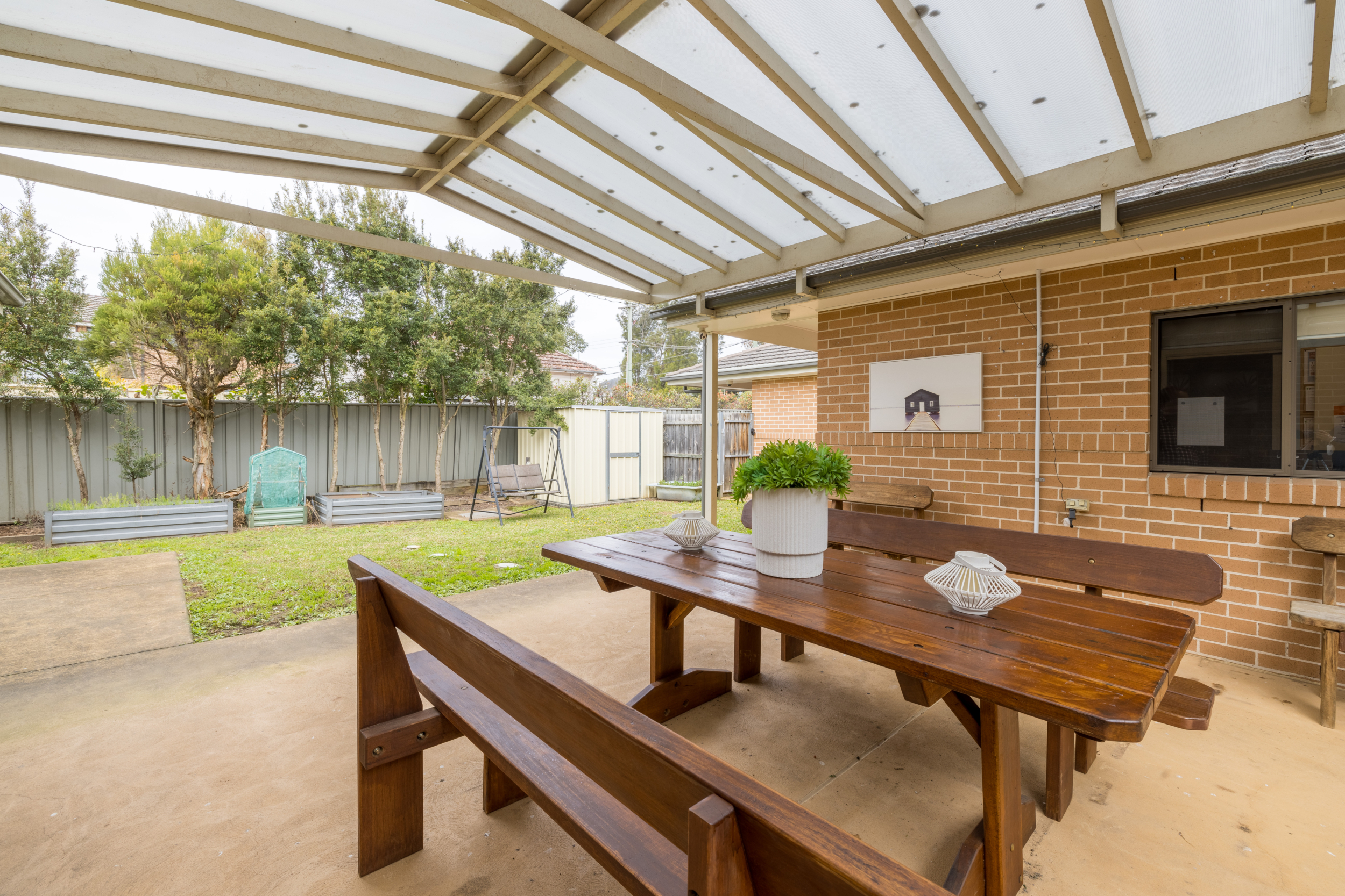 Backyard with BBQ swings and outdoor furniture