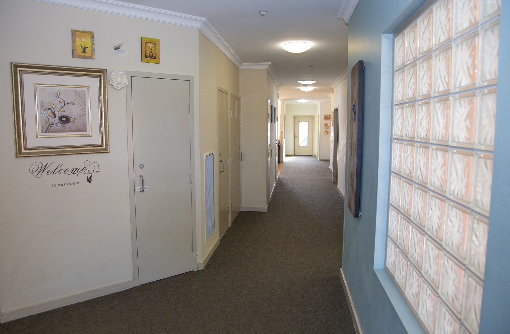 Hallway area with pictures on walls