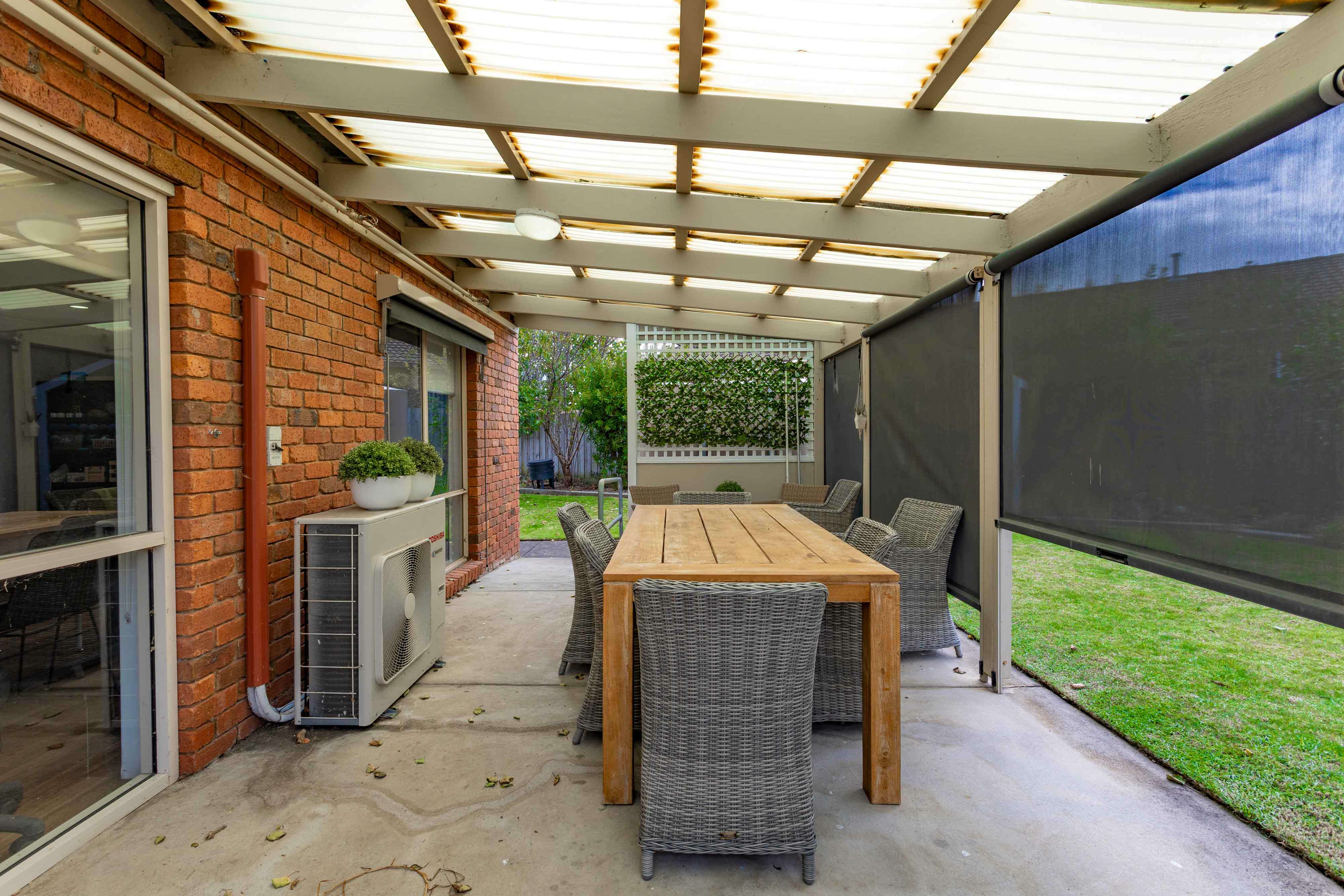 Undercover outdoor seating area with wooden table
