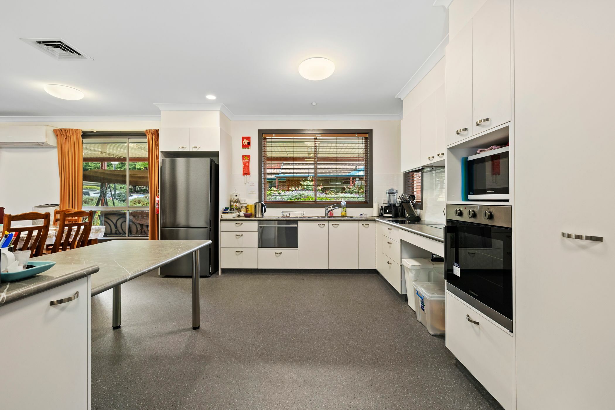 Kitchen area with white cabinetary and laminate benchtop