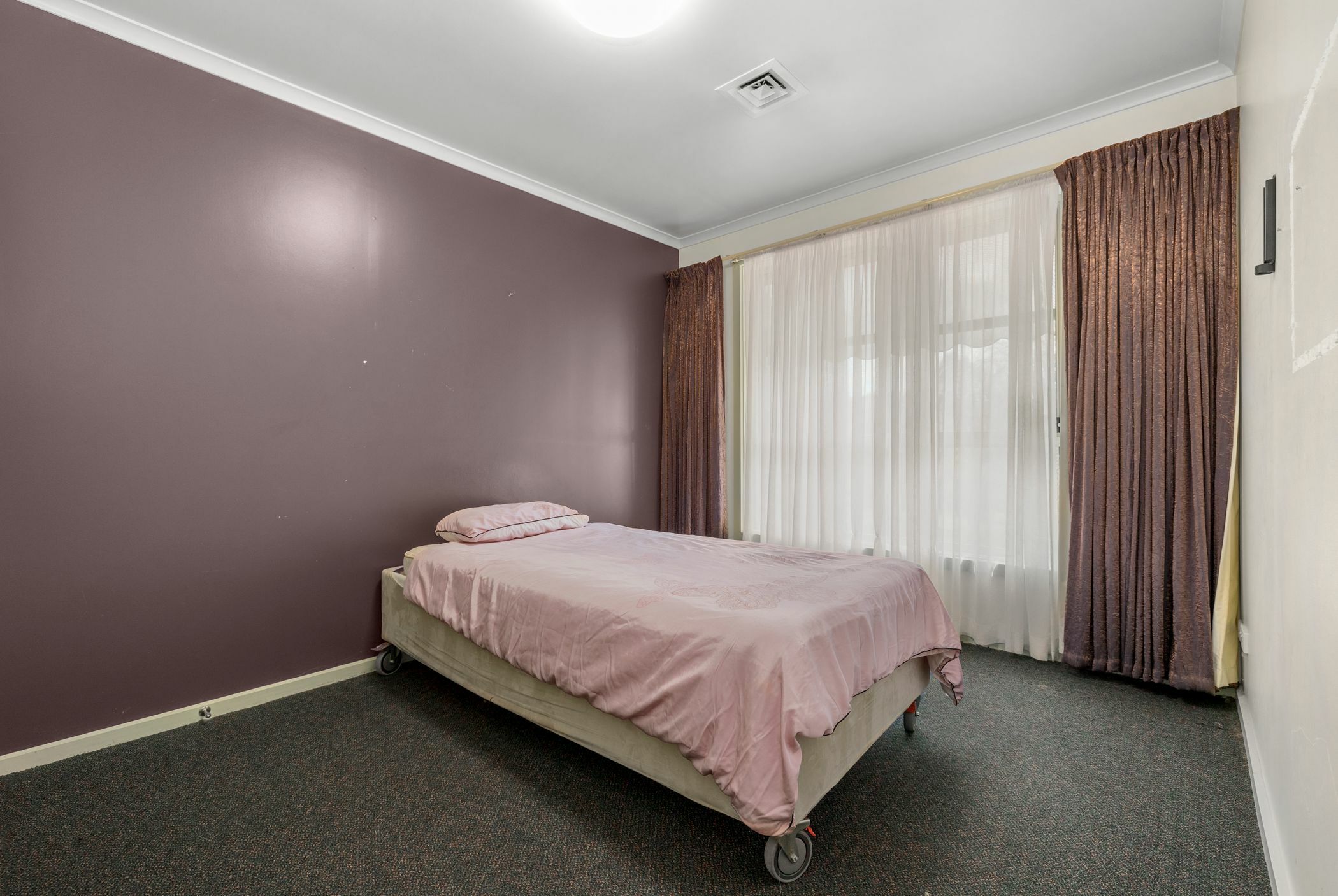 Bedroom with violet walls and drapes