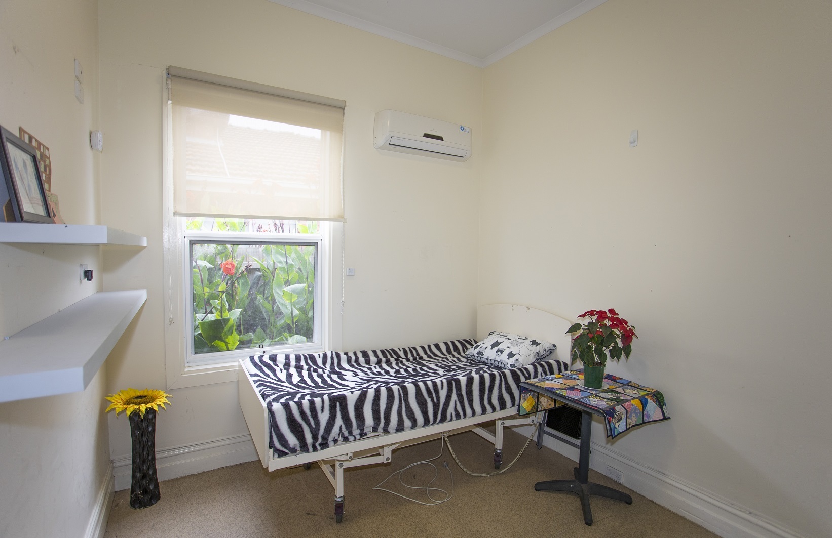 Bedroom with cream wallpaper in SDA home in Thornbury