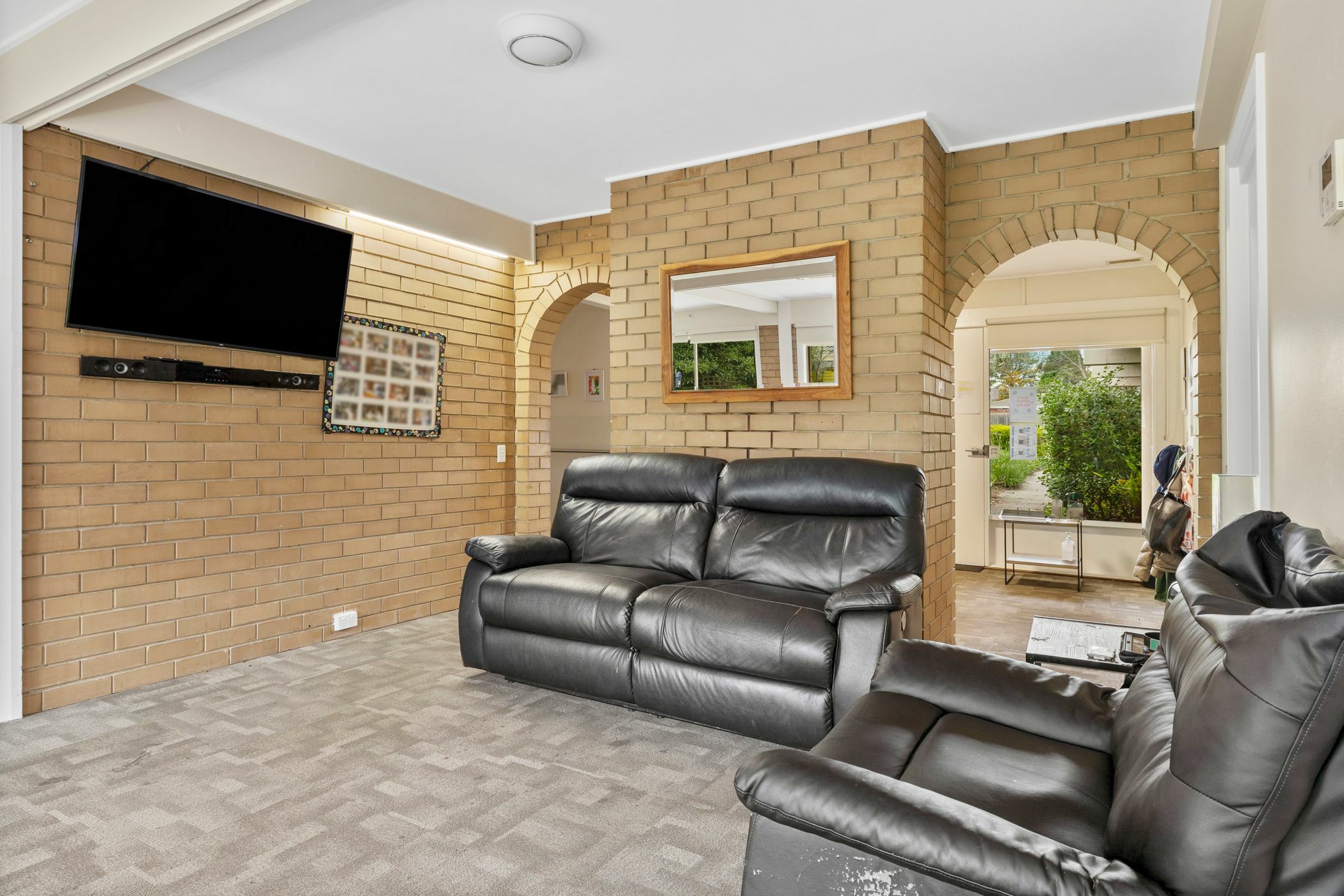 Living room area with black leather recliners