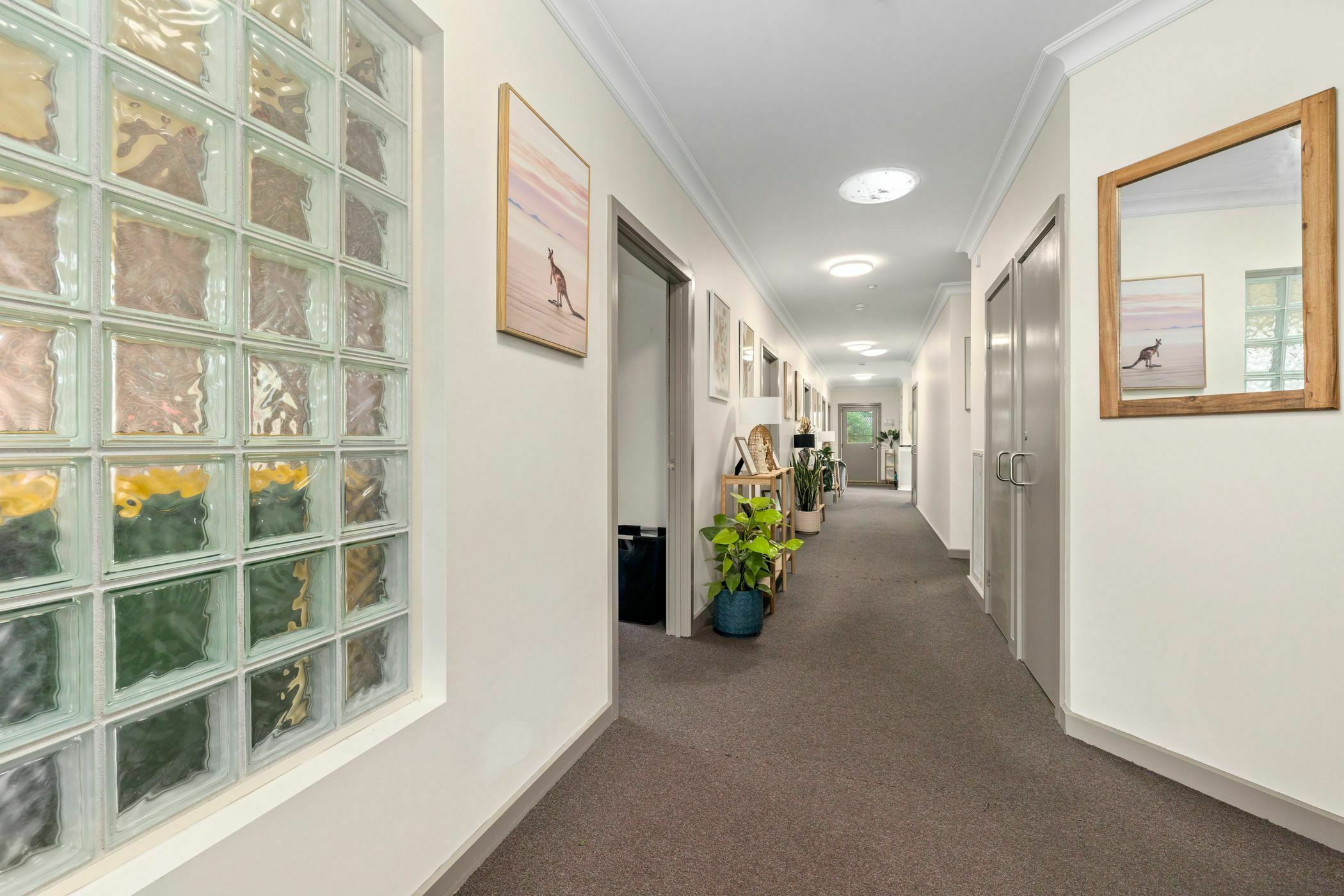 Hallway area with white wallpaper and wall art