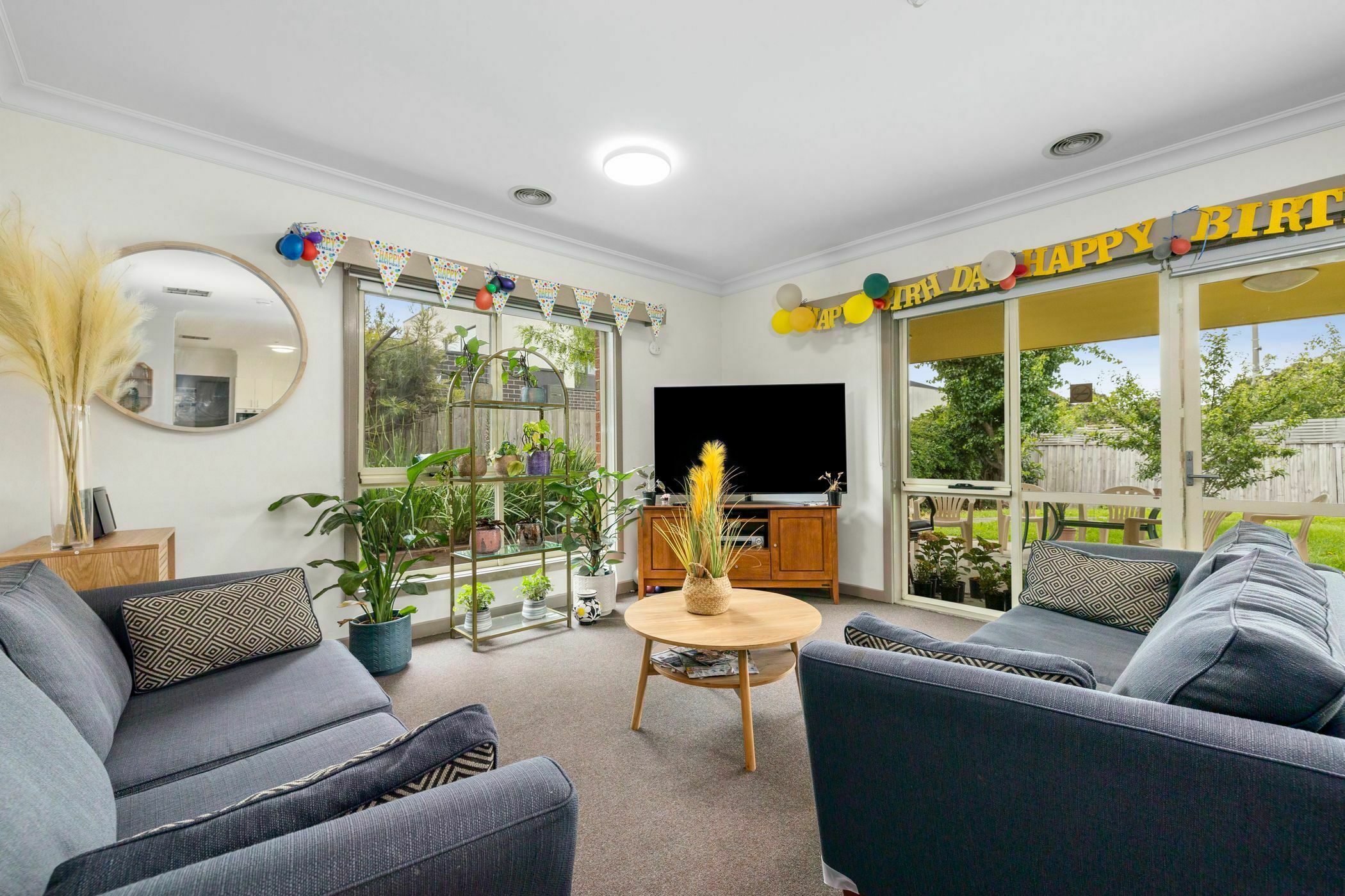 Living area with large tv and blue couches