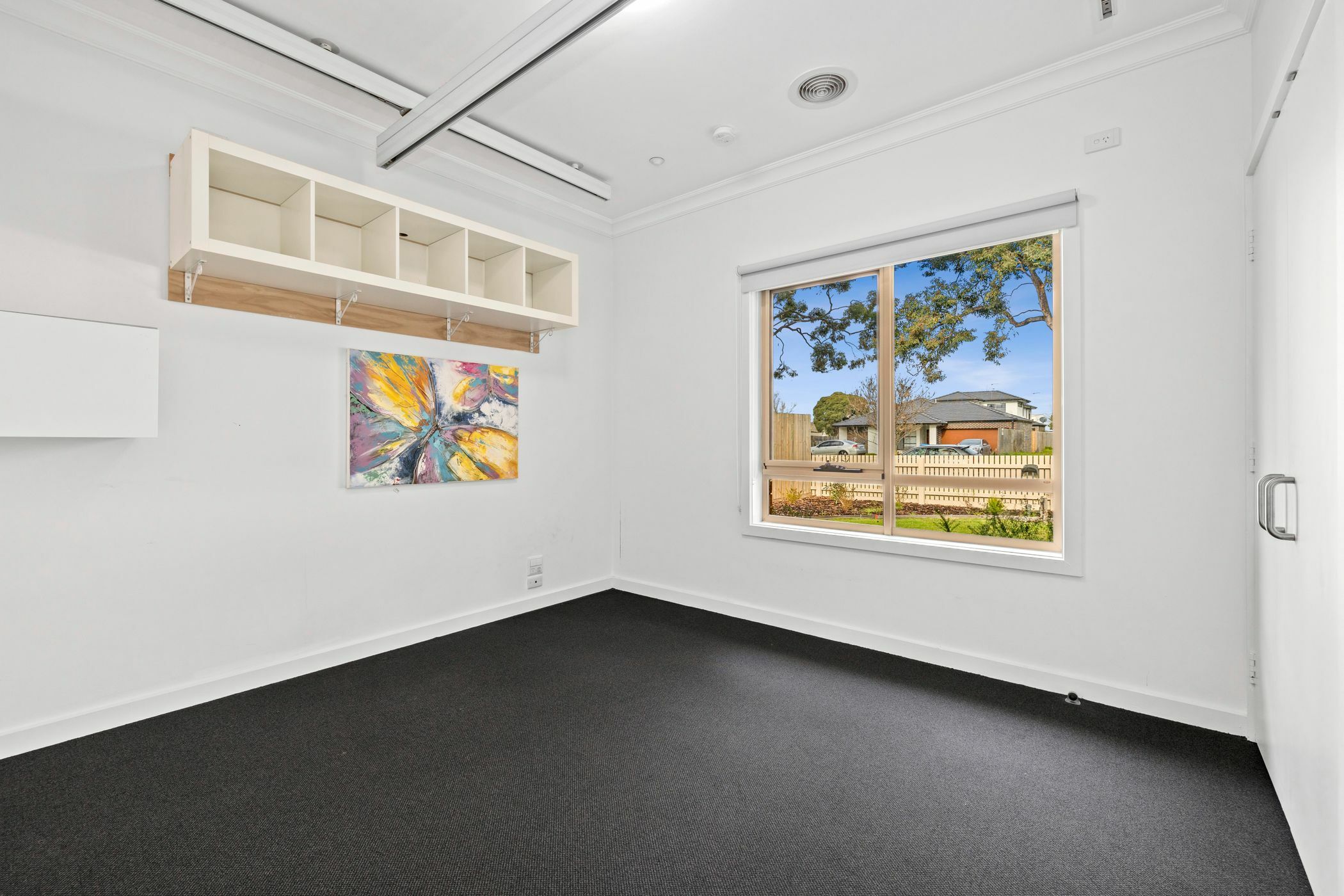 Bedroom with large window looking out to lawn