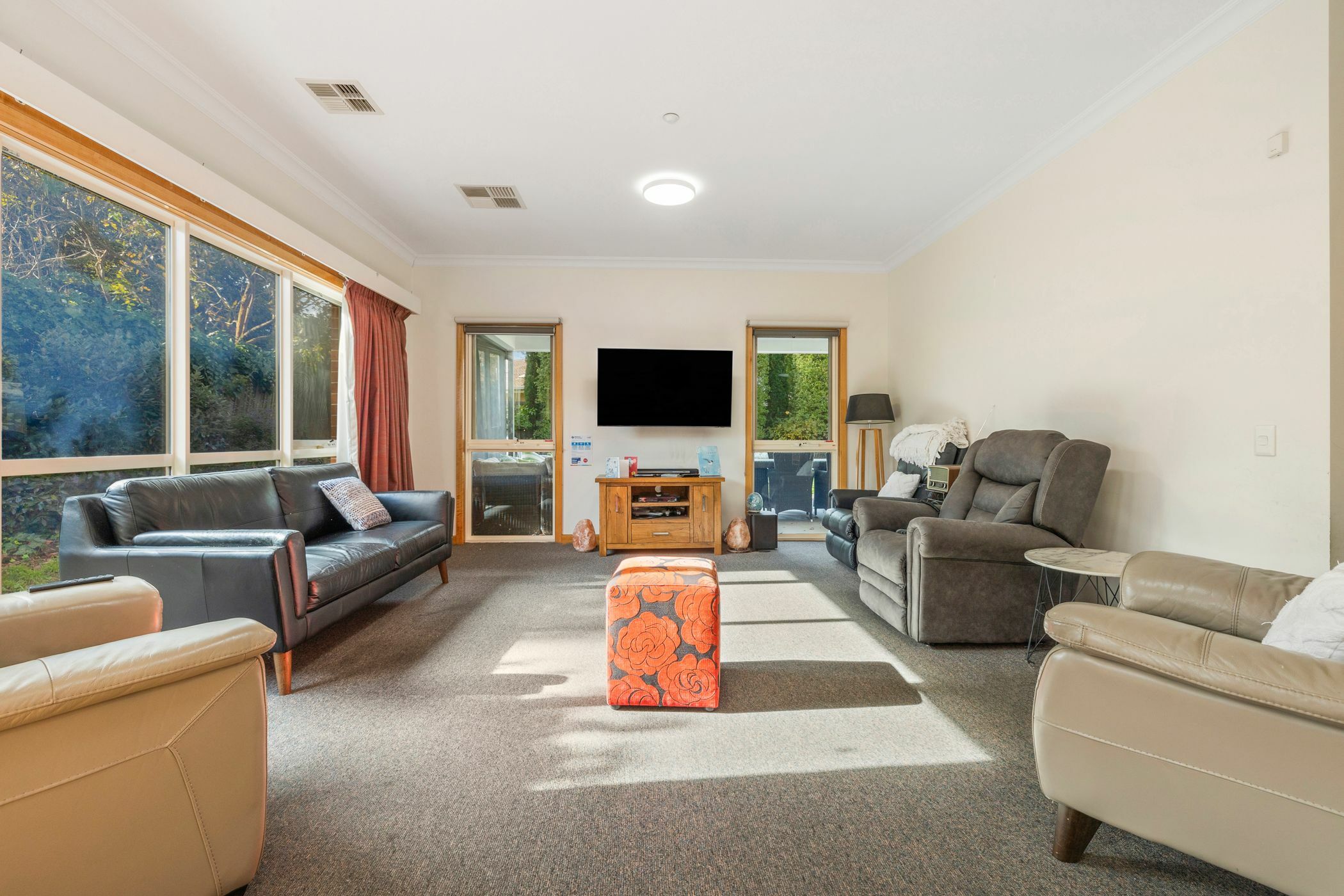 Well lit living area with multiple couches