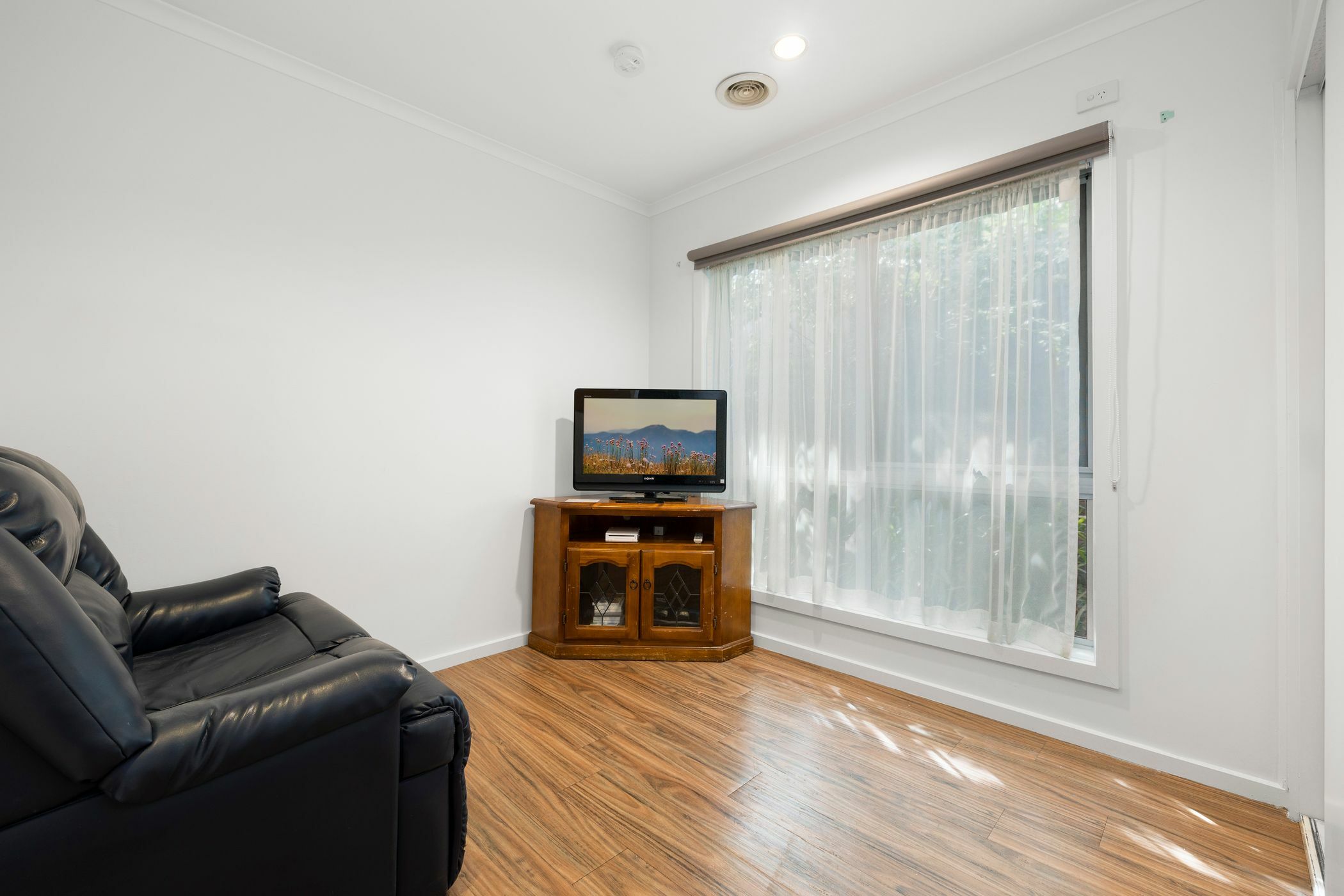 Second living room with a reclining chair and TV