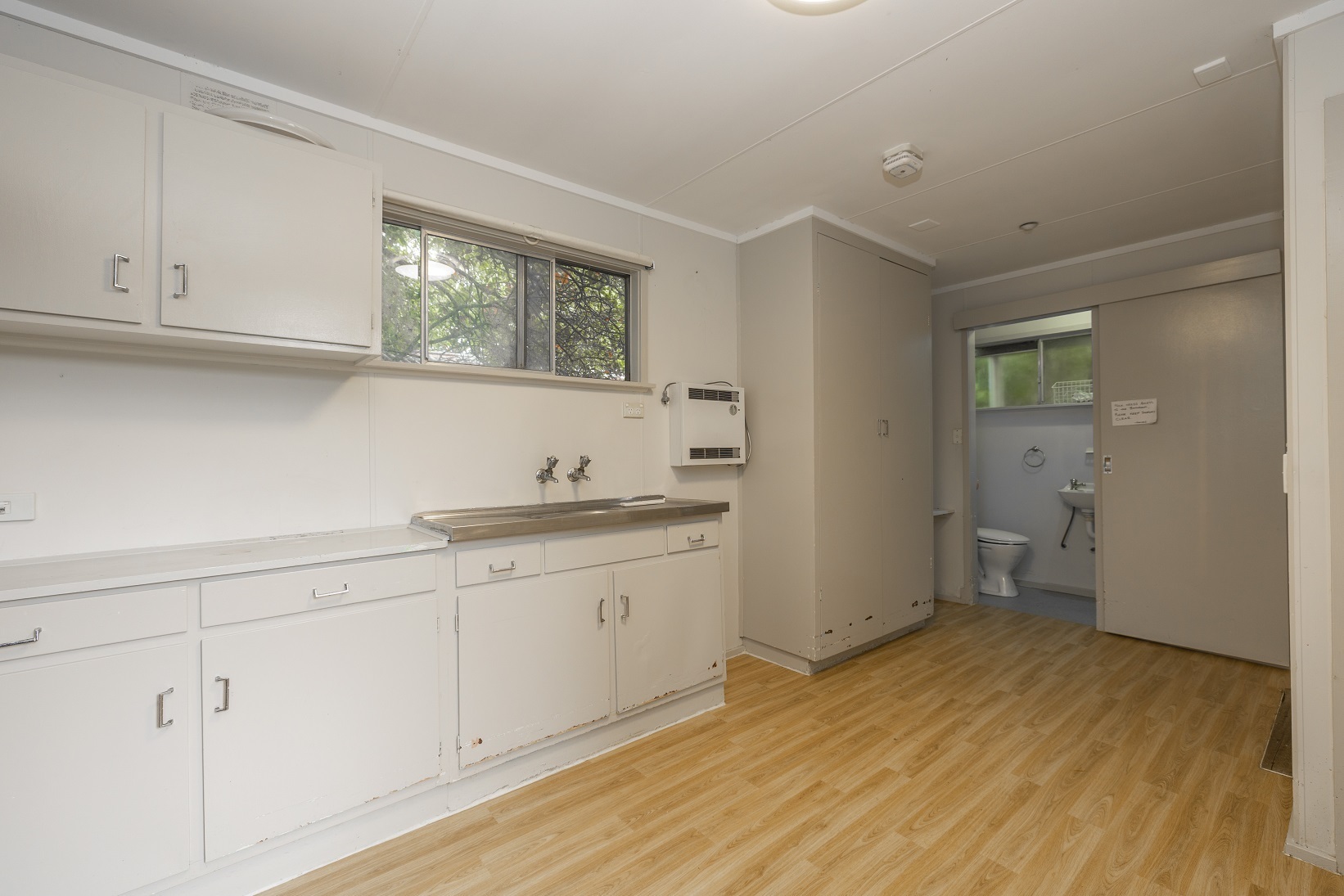 Cabinets in Kitchen and living area with toilet